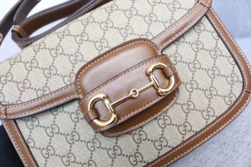 GUCCI 1955 Horsebit Shoulder Bag. Authentic quality luxury bag crafted in genuine leather comes with authenticity card, dust bag and gift bag. Timeless Elegance Meets Modern Versatility. The Gucci 1955 Horsebit bag, a recreation of an archival design, was introduced for Cruise 2020. Maintaining the same elegant lines and forms from over sixty years ago, this accessory seamlessly blends original details with a modern sensibility, placing emphasis on the iconic Horsebit. As an integral part of Gucci's genetic code, the double ring and bar design is recognized as one of the House's most distinctive elements drawn from the equestrian world. Showcased on a compact flap shoulder bag, the hardware is perfectly complemented by the House's recognizable monogram fabric. Furthermore, the bag incorporates a unique mechanism that allows for adjustable shoulder strap length, providing versatility for both shoulder and cross-body wear.