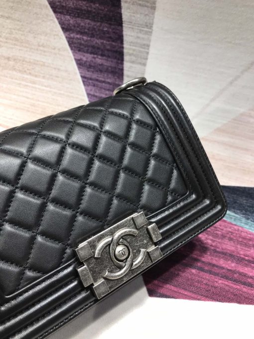 CHANEL Small Boy Handbag. Authentic quality luxury bag crafted in genuine leather comes with authenticity card, dust bag and gift bag. A legendary icon of masculine chic, designed by Karl Lagerfeld to capture the timeless allure of Coco Chanel's love story. The Boy, introduced in 2011, has quickly become an icon. Designed by Karl Lagerfeld and named after Coco Chanel's beloved Boy Capel, the bag embodies a masculine-chic aesthetic with its rigid structure, boxy shape, and sharp corners. This CHANEL Small Handbag is instantly recognizable for its clean, boxy silhouette and sharp corners. Its standout feature is a contrasting, bold-looking link chain strap. The most sought-after versions of the Chanel Boy come in caviar or lambskin, with no external pockets and the only embellishment being the quilted fascia.
