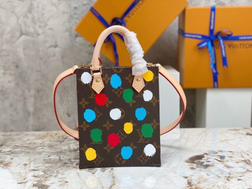 LOUIS VUITTON X Yayoi Kusama Petit Sac Plat. Authentic quality luxury bag crafted in genuine leather comes with authenticity card, dust bag and gift bag. Step into the world of art and style. The LVxYK Petit Sac Plat receives a vibrant artistic touch in the latest collaboration between LOUIS VUITTON and Yayoi Kusama. Showcasing a fusion of artistry and skill, this petite yet exquisite tote features the iconic Monogram canvas adorned with the celebrated Japanese artist's signature dots, a motif that is frequently seen in her captivating artworks. As a result, it transforms into a lively and innovative rendition of a sophisticated and user-friendly clutch, adding a burst of creativity and color to any ensemble.