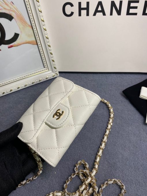 CHANEL Classic Mini Clutch With Chain. Authentic quality luxury bag crafted in genuine leather comes with authenticity card, dust bag and gift bag. Elegance in a Compact Size. The Chanel Classic Mini Clutch is a truly authentic beauty, as it bears a striking resemblance to the iconic Classic Flap Bag. Additionally, it is the compact version of the Clutch With Chain Bag. Despite its small size, this Mini Clutch offers numerous advantages. Notably, it includes a lengthy chain that allows for effortless shoulder carry. This versatile handbag can function as an extra wallet within a larger bag during the day, and as a charming evening accessory during the night.