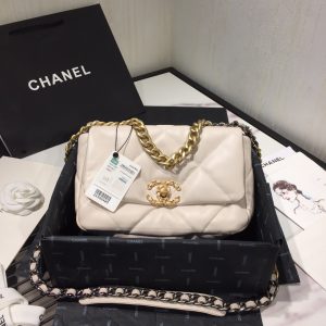 CHANEL '19' Flap Bag. Authentic quality luxury bag crafted in genuine leather comes with authenticity card, dust bag and gift bag. A Timeless Evolution of Elegance. Chanel's latest masterpiece, the Chanel 19 Bag, is the result of a collaboration with the brilliant designer Virginie Viard. This exquisite creation took center stage at the prestigious Paris Fashion Week, captivating fashion enthusiasts from around the world. Aptly named after its birth year, the Chanel 19 Bag draws inspiration from the iconic 2.55 bag, paying homage to its timeless elegance. - KRIS + KIKO CHANEL '19' Flap Bag. High-end quality bag including gift box, literature, dust bag, authenticity card. Chanel's newest bag was designed along with Virginie Viard, and it made its debut on the runway of Paris Fashion Week earlier this year. The bag, called the Chanel 19 Bag, is aptly named after its birth year, and it is said to be inspired by the classic 2.55 bag.