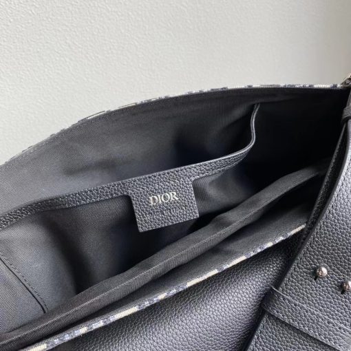 DIOR Saddle Messenger Bag. Authentic quality luxury bag crafted in genuine leather comes with authenticity card, dust bag and gift bag. Elegance Meets Functionality. Introducing the Saddle messenger bag, an understated yet sophisticated choice with a timeless silhouette. Meticulously crafted from high-quality black grained calfskin, this splendid accessory showcases a flap adorned with iconic Saddle lines, beautifully complemented by a tasteful 'DIOR' signature. Its versatile adjustable shoulder strap enables effortless wear, whether over the shoulder or crossbody. Inside, the spacious interior presents a practical patch pocket, generously accommodating a 13-inch laptop, important documents, and even a tablet. With its seamless blend of style and functionality, this bag is an ideal companion for your everyday needs.