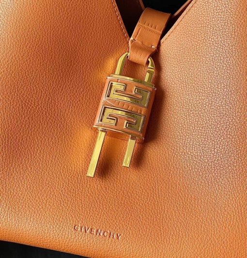 GIVENCHY Medium G-Hobo Bag. Authentic quality luxury bag crafted in genuine leather comes with authenticity card, dust bag and gift bag. Slouched sophistication meets iconic embellishments! The G-Hobo Medium shoulder bag by Givenchy showcases an effortlessly chic, triangular shape that exudes a laid-back appeal. Crafted from luxurious calf leather, this design stays true to the brand's signature aesthetic. Its allure is further amplified by the addition of the iconic 4G padlock and croc-effect straps, making it a true standout piece.