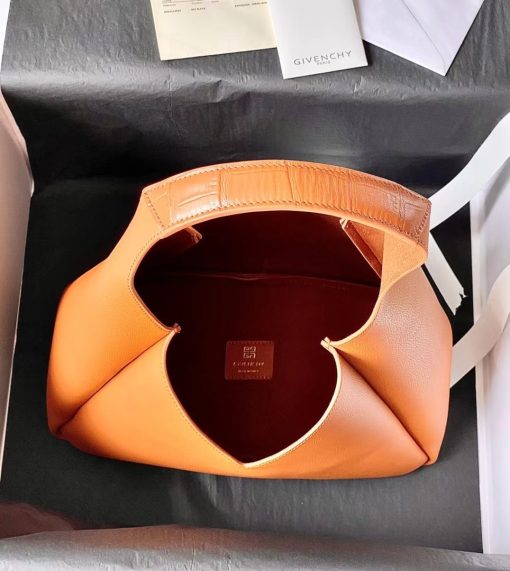 GIVENCHY Medium G-Hobo Bag. Authentic quality luxury bag crafted in genuine leather comes with authenticity card, dust bag and gift bag. Slouched sophistication meets iconic embellishments! The G-Hobo Medium shoulder bag by Givenchy showcases an effortlessly chic, triangular shape that exudes a laid-back appeal. Crafted from luxurious calf leather, this design stays true to the brand's signature aesthetic. Its allure is further amplified by the addition of the iconic 4G padlock and croc-effect straps, making it a true standout piece.