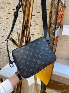 LOUIS VUITTON Steamer Messenger. Authentic quality luxury bag crafted in genuine leather comes with authenticity card, dust bag and gift bag. Timeless Elegance Meets Modern Functionality. Introducing the elegant addition to the New Classics collection - the Messenger. Imbued with the timeless sophistication of LOUIS VUITTON heritage, this exquisite piece showcases the fusion of supple Monogram Taurillon leather and Monogram Eclipse canvas. Signature details, such as the steamer-style chain, adorn this messenger beautifully. Boasting practicality, it is effortlessly carried with its removable strap. Inside, a generous zipped compartment awaits, ensuring ample storage, while a front flap pocket with a secure magnetic closure provides added convenience. - KRIS + KIKO LOUIS VUITTON Steamer Messenger. Authentic quality luxury bag crafted in genuine leather comes with authenticity card, dust bag and gift bag. Timeless Elegance Meets Modern Functionality. Introducing the elegant addition to the New Classics collection - the Messenger. Imbued with the timeless sophistication of LOUIS VUITTON heritage, this exquisite piece showcases the fusion of supple Monogram Taurillon leather and Monogram Eclipse canvas. Signature details, such as the steamer-style chain, adorn this messenger beautifully. Boasting practicality, it is effortlessly carried with its removable strap. Inside, a generous zipped compartment awaits, ensuring ample storage, while a front flap pocket with a secure magnetic closure provides added convenience.