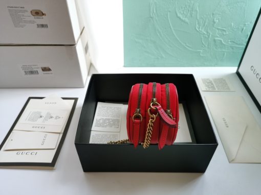 GUCCI GG Marmont Mini Chain Bag. Authentic quality luxury bag crafted in genuine leather comes with authenticity card, dust bag and gift bag. Style meets functionality in a compact and adorable package. The GG Marmont Mini Chain Bag is exquisitely adorned with chevron leather and features a delightful heart embellishment on its back. Its slender, softly structured form boasts three convenient zippered compartments. The front showcases the ultra-stylish GG logo, painstakingly crafted with antique gold hardware, lending a touch of vintage charm. The interior is lined with moiré and microfiber, pleasantly resembling suede. In addition, two card slots and a 60cm drop chain strap are included. Despite its compact size, this bag is undeniably cute, especially when elegantly draped over the shoulder.