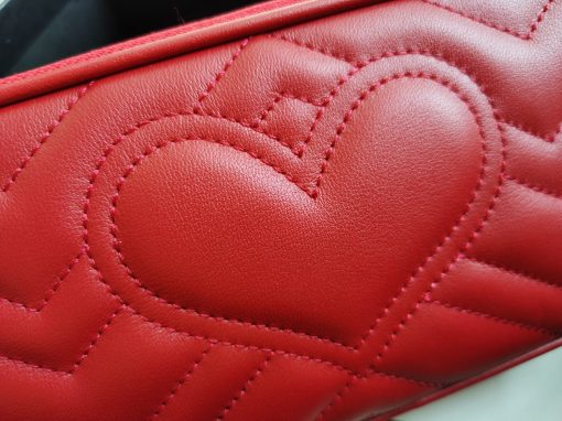 GUCCI GG Marmont Mini Chain Bag. Authentic quality luxury bag crafted in genuine leather comes with authenticity card, dust bag and gift bag. Style meets functionality in a compact and adorable package. The GG Marmont Mini Chain Bag is exquisitely adorned with chevron leather and features a delightful heart embellishment on its back. Its slender, softly structured form boasts three convenient zippered compartments. The front showcases the ultra-stylish GG logo, painstakingly crafted with antique gold hardware, lending a touch of vintage charm. The interior is lined with moiré and microfiber, pleasantly resembling suede. In addition, two card slots and a 60cm drop chain strap are included. Despite its compact size, this bag is undeniably cute, especially when elegantly draped over the shoulder.