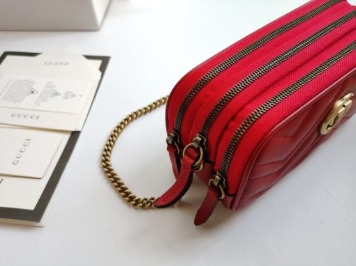 GUCCI GG Marmont Mini Chain Bag. Authentic quality luxury bag crafted in genuine leather comes with authenticity card, dust bag and gift bag. Style meets functionality in a compact and adorable package. The GG Marmont Mini Chain Bag is exquisitely adorned with chevron leather and features a delightful heart embellishment on its back. Its slender, softly structured form boasts three convenient zippered compartments. The front showcases the ultra-stylish GG logo, painstakingly crafted with antique gold hardware, lending a touch of vintage charm. The interior is lined with moiré and microfiber, pleasantly resembling suede. In addition, two card slots and a 60cm drop chain strap are included. Despite its compact size, this bag is undeniably cute, especially when elegantly draped over the shoulder.