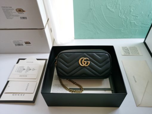 GUCCI GG Marmont Mini Chain Bag. Authentic quality luxury bag crafted in genuine leather comes with authenticity card, dust bag and gift bag. Style meets functionality in a compact and adorable package. The GG Marmont Mini Chain Bag is exquisitely adorned with chevron leather and features a delightful heart embellishment on its back. Its slender, softly structured form boasts three convenient zippered compartments. The front showcases the ultra-stylish GG logo, painstakingly crafted with antique gold hardware, lending a touch of vintage charm. The interior is lined with moiré and microfiber, pleasantly resembling suede. In addition, two card slots and a 60cm drop chain strap are included. Despite its compact size, this bag is undeniably cute, especially when elegantly draped over the shoulder.
