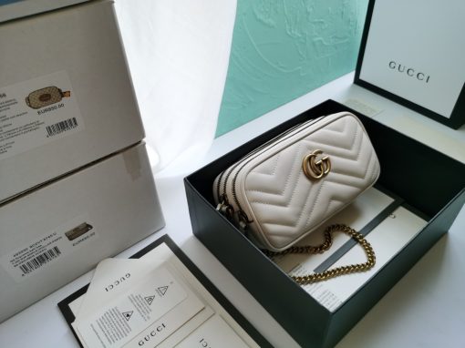 GUCCI GG Marmont Mini Chain Bag. Authentic quality luxury bag crafted in genuine leather comes with authenticity card, dust bag and gift bag. Style meets functionality in a compact and adorable package. The GG Marmont Mini Chain Bag is exquisitely adorned with chevron leather and features a delightful heart embellishment on its back. Its slender, softly structured form boasts three convenient zippered compartments. The front showcases the ultra-stylish GG logo, painstakingly crafted with antique gold hardware, lending a touch of vintage charm. The interior is lined with moiré and microfiber, pleasantly resembling suede. In addition, two card slots and a 60cm drop chain strap are included. Despite its compact size, this bag is undeniably cute, especially when elegantly draped over the shoulder.