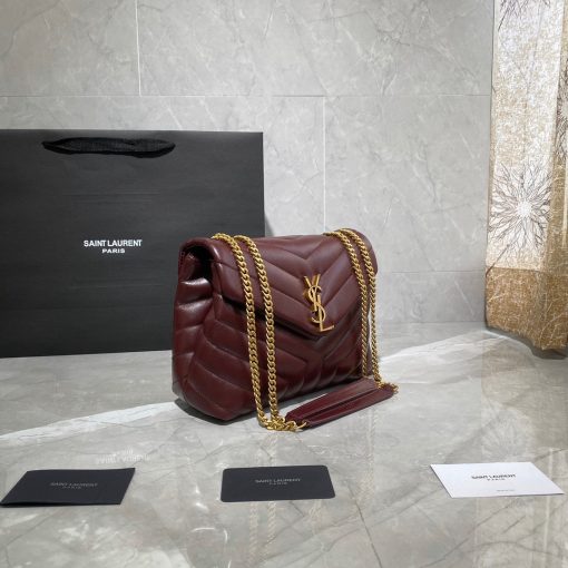 SAINT LAURENT Small Loulou Matelassé Bag. Authentic quality luxury bag crafted in genuine leather comes with authenticity card, dust bag and gift bag. Femininity meets rock and roll elegance. The SAINT LAURENT Small Loulou Matelassé Bag exudes a timeless femininity with a hint of edgy rock and roll. Its standout feature is the padded quilted leather, adding dimension and volume to the bag. The leather chain handles and iconic metal interlocking YSL initials on the front flap make a bold yet timeless statement of luxury. The versatility of this bag is another noteworthy aspect, as it effortlessly transitions from casual to formal occasions. The moveable chain strap allows for it to be worn as a crossbody bag, further enhancing its adaptability.