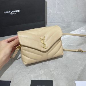SAINT LAURENT Toy Loulou Matelassé Mini Bag. Authentic quality luxury bag crafted in genuine leather comes with authenticity card, dust bag and gift bag. Embrace Your Inner Rock and Roll Chic. The SAINT LAURENT Toy Loulou Matelassé Mini Bag can be described as a beautifully feminine accessory with a touch of rebellious charm. Its standout feature is the padded quilted leather, which adds volume and texture. The leather chain handles and metal interlocking YSL initials on the front flap give the bag a daring yet timeless allure, making it a luxurious statement piece. The versatility of the YSL LouLou bag is truly impressive, as it can effortlessly transition from casual to formal occasions. The adjustable chain strap allows for the option of wearing it as a crossbody bag, adding to its adaptability. - KRIS + KIKO SAINT LAURENT Toy Loulou Matelassé Mini Bag. If asked to describe the design of the SAINT LAURENT Toy Loulou Matelassé Mini Bag in a few words, we’d say that it is a feminine bag with a slight rock and roll feel to it. One of the most noticeable things about the look of the LouLou is the padded quilted leather, a feature which gives the bag more volume. The leather padded chain handles and the metal interlocking YSL initials on the front flap, make it a bold, yet still classic, luxury handbag. Versatility is another strong point of the YSL LouLou bag, and it can definitely be dressed up or down for any occasion. The chain strap is moveable, which means it can also be worn as a crossbody bag.