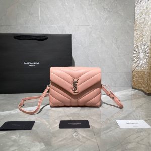 SAINT LAURENT Toy Loulou Matelassé Mini Bag. Authentic quality luxury bag crafted in genuine leather comes with authenticity card, dust bag and gift bag. Embrace Your Inner Rock and Roll Chic. The SAINT LAURENT Toy Loulou Matelassé Mini Bag can be described as a beautifully feminine accessory with a touch of rebellious charm. Its standout feature is the padded quilted leather, which adds volume and texture. The leather chain handles and metal interlocking YSL initials on the front flap give the bag a daring yet timeless allure, making it a luxurious statement piece. The versatility of the YSL LouLou bag is truly impressive, as it can effortlessly transition from casual to formal occasions. The adjustable chain strap allows for the option of wearing it as a crossbody bag, adding to its adaptability. - KRIS + KIKO SAINT LAURENT Toy Loulou Matelassé Mini Bag. If asked to describe the design of the SAINT LAURENT Toy Loulou Matelassé Mini Bag in a few words, we’d say that it is a feminine bag with a slight rock and roll feel to it. One of the most noticeable things about the look of the LouLou is the padded quilted leather, a feature which gives the bag more volume. The leather padded chain handles and the metal interlocking YSL initials on the front flap, make it a bold, yet still classic, luxury handbag. Versatility is another strong point of the YSL LouLou bag, and it can definitely be dressed up or down for any occasion. The chain strap is moveable, which means it can also be worn as a crossbody bag.