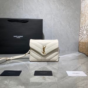 SAINT LAURENT Toy Loulou Matelassé Mini Bag. Authentic quality luxury bag crafted in genuine leather comes with authenticity card, dust bag and gift bag. Embrace Your Inner Rock and Roll Chic. The SAINT LAURENT Toy Loulou Matelassé Mini Bag can be described as a beautifully feminine accessory with a touch of rebellious charm. Its standout feature is the padded quilted leather, which adds volume and texture. The leather chain handles and metal interlocking YSL initials on the front flap give the bag a daring yet timeless allure, making it a luxurious statement piece. The versatility of the YSL LouLou bag is truly impressive, as it can effortlessly transition from casual to formal occasions. The adjustable chain strap allows for the option of wearing it as a crossbody bag, adding to its adaptability. - KRIS + KIKO SAINT LAURENT Toy Loulou Matelassé Mini Bag. Authentic quality luxury bag crafted in genuine leather comes with authenticity card, dust bag and gift bag. Embrace Your Inner Rock and Roll Chic. The SAINT LAURENT Toy Loulou Matelassé Mini Bag can be described as a beautifully feminine accessory with a touch of rebellious charm. Its standout feature is the padded quilted leather, which adds volume and texture. The leather chain handles and metal interlocking YSL initials on the front flap give the bag a daring yet timeless allure, making it a luxurious statement piece. The versatility of the YSL LouLou bag is truly impressive, as it can effortlessly transition from casual to formal occasions. The adjustable chain strap allows for the option of wearing it as a crossbody bag, adding to its adaptability.