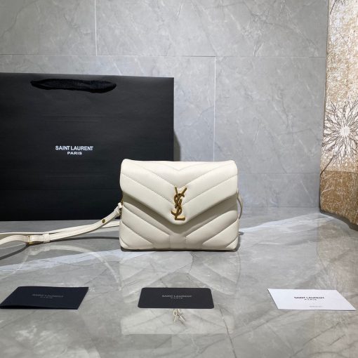 SAINT LAURENT Toy Loulou Matelassé Mini Bag. Authentic quality luxury bag crafted in genuine leather comes with authenticity card, dust bag and gift bag. Embrace Your Inner Rock and Roll Chic. The SAINT LAURENT Toy Loulou Matelassé Mini Bag can be described as a beautifully feminine accessory with a touch of rebellious charm. Its standout feature is the padded quilted leather, which adds volume and texture. The leather chain handles and metal interlocking YSL initials on the front flap give the bag a daring yet timeless allure, making it a luxurious statement piece. The versatility of the YSL LouLou bag is truly impressive, as it can effortlessly transition from casual to formal occasions. The adjustable chain strap allows for the option of wearing it as a crossbody bag, adding to its adaptability.