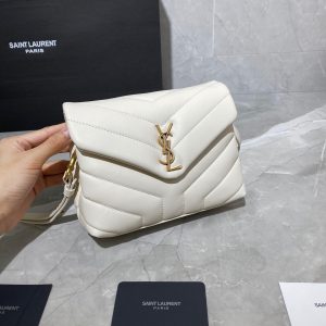 SAINT LAURENT Toy Loulou Matelassé Mini Bag. Authentic quality luxury bag crafted in genuine leather comes with authenticity card, dust bag and gift bag. Embrace Your Inner Rock and Roll Chic. The SAINT LAURENT Toy Loulou Matelassé Mini Bag can be described as a beautifully feminine accessory with a touch of rebellious charm. Its standout feature is the padded quilted leather, which adds volume and texture. The leather chain handles and metal interlocking YSL initials on the front flap give the bag a daring yet timeless allure, making it a luxurious statement piece. The versatility of the YSL LouLou bag is truly impressive, as it can effortlessly transition from casual to formal occasions. The adjustable chain strap allows for the option of wearing it as a crossbody bag, adding to its adaptability. - KRIS + KIKO SAINT LAURENT Toy Loulou Matelassé Mini Bag. If asked to describe the design of the SAINT LAURENT Toy Loulou Matelassé Mini Bag in a few words, we’d say that it is a feminine bag with a slight rock and roll feel to it. One of the most noticeable things about the look of the LouLou is the padded quilted leather, a feature which gives the bag more volume. The leather padded chain handles and the metal interlocking YSL initials on the front flap, make it a bold, yet still classic, luxury handbag. Versatility is another strong point of the YSL LouLou bag, and it can definitely be dressed up or down for any occasion. The chain strap is moveable, which means it can also be worn as a crossbody bag.