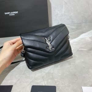 SAINT LAURENT Toy Loulou Matelassé Mini Bag. Authentic quality luxury bag crafted in genuine leather comes with authenticity card, dust bag and gift bag. Embrace Your Inner Rock and Roll Chic. The SAINT LAURENT Toy Loulou Matelassé Mini Bag can be described as a beautifully feminine accessory with a touch of rebellious charm. Its standout feature is the padded quilted leather, which adds volume and texture. The leather chain handles and metal interlocking YSL initials on the front flap give the bag a daring yet timeless allure, making it a luxurious statement piece. The versatility of the YSL LouLou bag is truly impressive, as it can effortlessly transition from casual to formal occasions. The adjustable chain strap allows for the option of wearing it as a crossbody bag, adding to its adaptability. - KRIS + KIKO SAINT LAURENT Toy Loulou Matelassé Mini Bag. If asked to describe the design of the SAINT LAURENT Toy Loulou Matelassé Mini Bag in a few words, we’d say that it is a feminine bag with a slight rock and roll feel to it. One of the most noticeable things about the look of the LouLou is the padded quilted leather, a feature which gives the bag more volume. The leather padded chain handles and the metal interlocking YSL initials on the front flap, make it a bold, yet still classic, luxury handbag. Versatility is another strong point of the YSL LouLou bag, and it can definitely be dressed up or down for any occasion. The chain strap is moveable, which means it can also be worn as a crossbody bag.