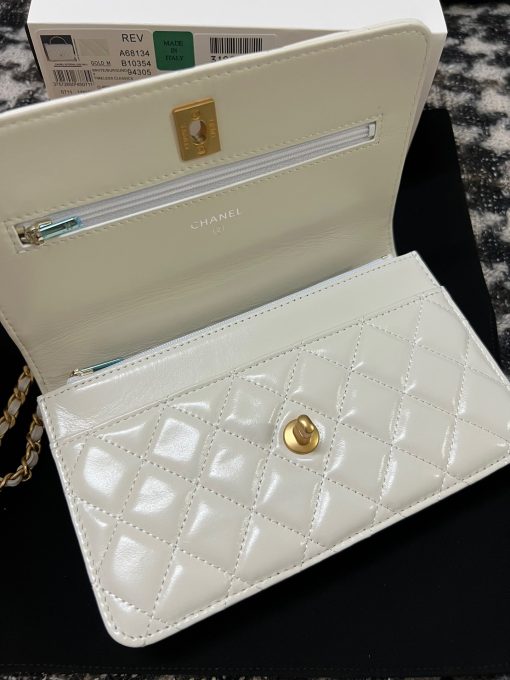 CHANEL Wallet On Chain With Signature Handle. Authentic quality luxury bag crafted in genuine leather comes with authenticity card, dust bag and gift bag. Elevate your style with this wallet  - where timeless design meets practical elegance. Introducing a stunning addition to Chanel's Spring Summer 2022 SLG Collection - a delightful seasonal bag. What sets this bag apart is its uniquely captivating design. Crafted meticulously with diamond quilting using premium calfskin, the center is elegantly embellished with a vintage golden CC logo. Its signature handle gracefully connects to a beautifully woven leather strap. Practicality meets style as this bag showcases a convenient back-pocket and a spacious main compartment with card holders and a chain pocket.