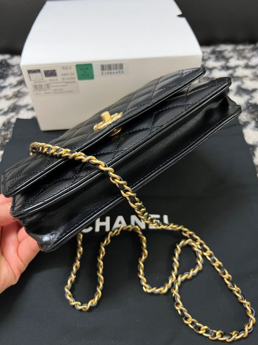 CHANEL Wallet On Chain With Signature Handle. Authentic quality luxury bag crafted in genuine leather comes with authenticity card, dust bag and gift bag. Elevate your style with this wallet  - where timeless design meets practical elegance. Introducing a stunning addition to Chanel's Spring Summer 2022 SLG Collection - a delightful seasonal bag. What sets this bag apart is its uniquely captivating design. Crafted meticulously with diamond quilting using premium calfskin, the center is elegantly embellished with a vintage golden CC logo. Its signature handle gracefully connects to a beautifully woven leather strap. Practicality meets style as this bag showcases a convenient back-pocket and a spacious main compartment with card holders and a chain pocket.