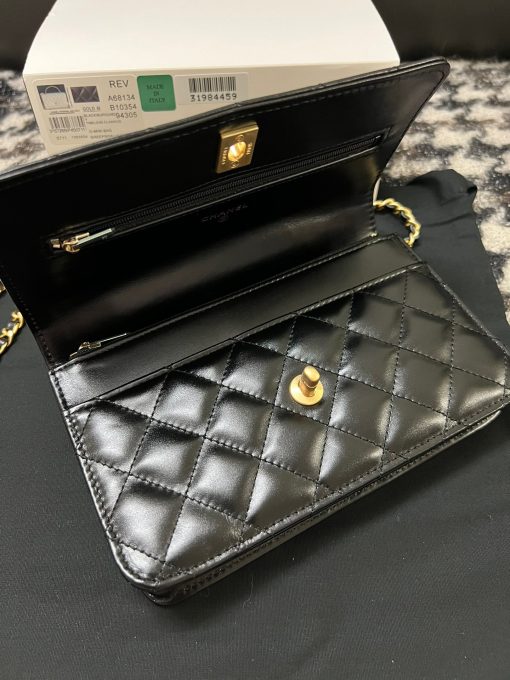 CHANEL Wallet On Chain With Signature Handle. Authentic quality luxury bag crafted in genuine leather comes with authenticity card, dust bag and gift bag. Elevate your style with this wallet  - where timeless design meets practical elegance. Introducing a stunning addition to Chanel's Spring Summer 2022 SLG Collection - a delightful seasonal bag. What sets this bag apart is its uniquely captivating design. Crafted meticulously with diamond quilting using premium calfskin, the center is elegantly embellished with a vintage golden CC logo. Its signature handle gracefully connects to a beautifully woven leather strap. Practicality meets style as this bag showcases a convenient back-pocket and a spacious main compartment with card holders and a chain pocket.