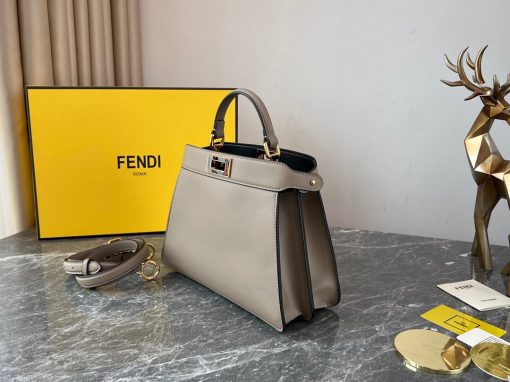 FENDI Peekaboo Iseeu Small Bag. Authentic quality luxury bag crafted in genuine leather comes with authenticity card, dust bag and gift bag. Unveil your style with the ISeeU: A small, iconic bag that speaks volumes. Introducing the sleek and timeless ISeeU bag, a compact yet noteworthy Peekaboo design meticulously crafted from luxurious leather. This exquisite creation is adorned with the iconic twist lock on both sides, enhancing its elegance. Versatility is at its core, as this bag can be effortlessly carried by hand or daintily worn on the shoulder or cross-body. With its convenient handle and adjustable, detachable shoulder strap, the choice is yours to embrace your personal style.
