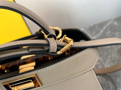 FENDI Peekaboo Iseeu Small Bag. Authentic quality luxury bag crafted in genuine leather comes with authenticity card, dust bag and gift bag. Unveil your style with the ISeeU: A small, iconic bag that speaks volumes. Introducing the sleek and timeless ISeeU bag, a compact yet noteworthy Peekaboo design meticulously crafted from luxurious leather. This exquisite creation is adorned with the iconic twist lock on both sides, enhancing its elegance. Versatility is at its core, as this bag can be effortlessly carried by hand or daintily worn on the shoulder or cross-body. With its convenient handle and adjustable, detachable shoulder strap, the choice is yours to embrace your personal style.