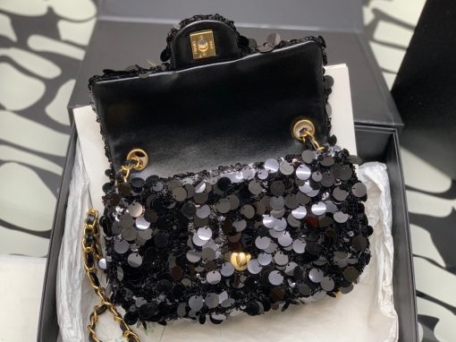 CHANEL Mini Flap Bag In Sequins. Authentic quality luxury bag comes with authenticity card, dust bag and gift bag. Sequins and Sophistication: Elevate Your Style with Timeless Elegance. This exquisite flap bag showcases a combination of small and large sequins meticulously arranged to cover the entirety of its surface. The sophisticated design includes refined leather shoulder straps adorned with polished chain links, as well as a chic CC turn lock. Opening the bag reveals a spacious leather interior that can accommodate all your essential items for both day and evening occasions while maintaining its timeless allure.