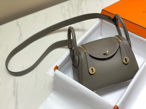 HERMÈS Mini Lindy. Authentic quality luxury bag crafted in genuine leather comes with authenticity card, dust bag and gift bag. Elevating Elegance. Maison HERMÈS is taking the Lindy a notch higher with the exciting addition of the new Mini, thus joining the esteemed holy Trinity of iconic bags - the Birkin, Kelly, and Constance.