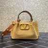 VALENTINO GARAVANI Straw Summer Small Tote. Authentic quality luxury bag crafted in genuine leather comes with authenticity card, dust bag and gift bag. Embrace Summer with Style: The Tote Bag that Defines Elegance and Valor. The Summer tote bag stands out with its intricately woven raffia pattern and the iconic brass-toned VLogo plaque, which embodies the unmistakable essence of Valentino Garavani. Its detachable shoulder strap is embellished with the renowned Roman Studs, an emblematic hallmark of the brand.