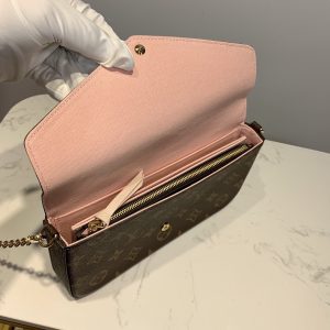 LOUIS VUITTON Pochette Félicie. Authentic quality luxury bag crafted in genuine leather comes with authenticity card, dust bag and gift bag. Elevate your essentials with the Pochette Félicie: Where style meets practicality. The Pochette Félicie in Monogram canvas presents itself as a chic and practical answer to effortlessly carry and arrange your everyday necessities. This adaptable pouch showcases two detachable pockets, including one designed with numerous card slots for your convenience. With the option to elegantly carry it as a clutch or drape it on your shoulder, courtesy of its removable gold-tone chain, versatility becomes its defining feature. - KRIS + KIKO LOUIS VUITTON Pochette Félicie. Original quality bag including gift box, literature, dust bag, authenticity card. The Pochette Félicie in Monogram canvas is a stylish solution to carry and organize daily essentials. This versatile pouch features two removable pockets, including one with several card slots. It can be carried as a clutch or a shoulder bag thanks to a removable gold-tone chain.