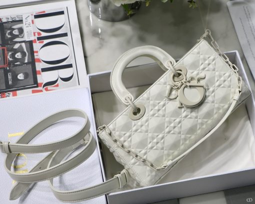 DIOR Lady D-Joy Bag. Authentic quality luxury bag crafted in genuine leather comes with authenticity card, dust bag and gift bag. Embrace timeless elegance - where beauty meets versatility. Exquisitely crafted from Cannage calfskin, this bag perfectly captures the House's unwavering commitment to elegance and beauty. Embodying the iconic streamlined aesthetic of the Lady Dior line, its refined and timeless style is further accentuated by the addition of meticulously designed metal 'D.I.O.R.' charms, gracing its silhouette with elegance. With its versatility in mind, this remarkable bag offers both a removable chain shoulder strap and an adjustable and removable leather shoulder strap, allowing it to be carried by hand or worn crossbody, making it the perfect daily companion.
