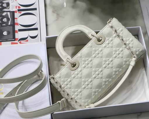 DIOR Lady D-Joy Bag. Authentic quality luxury bag crafted in genuine leather comes with authenticity card, dust bag and gift bag. Embrace timeless elegance - where beauty meets versatility. Exquisitely crafted from Cannage calfskin, this bag perfectly captures the House's unwavering commitment to elegance and beauty. Embodying the iconic streamlined aesthetic of the Lady Dior line, its refined and timeless style is further accentuated by the addition of meticulously designed metal 'D.I.O.R.' charms, gracing its silhouette with elegance. With its versatility in mind, this remarkable bag offers both a removable chain shoulder strap and an adjustable and removable leather shoulder strap, allowing it to be carried by hand or worn crossbody, making it the perfect daily companion.