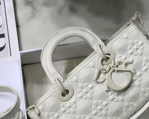 DIOR Lady D-Joy Bag. Authentic quality luxury bag crafted in genuine leather comes with authenticity card, dust bag and gift bag. Embrace timeless elegance - where beauty meets versatility. Exquisitely crafted from Cannage calfskin, this bag perfectly captures the House's unwavering commitment to elegance and beauty. Embodying the iconic streamlined aesthetic of the Lady Dior line, its refined and timeless style is further accentuated by the addition of meticulously designed metal 'D.I.O.R.' charms, gracing its silhouette with elegance. With its versatility in mind, this remarkable bag offers both a removable chain shoulder strap and an adjustable and removable leather shoulder strap, allowing it to be carried by hand or worn crossbody, making it the perfect daily companion.
