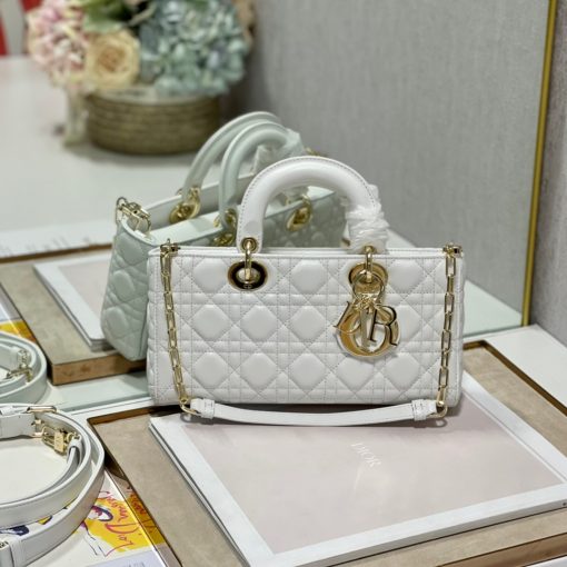 DIOR Lady D-Joy Bag. Authentic quality luxury bag crafted in genuine leather comes with authenticity card, dust bag and gift bag. Embrace timeless elegance - where beauty meets versatility. Exquisitely crafted from Cannage calfskin, this bag perfectly captures the House's unwavering commitment to elegance and beauty. Embodying the iconic streamlined aesthetic of the Lady Dior line, its refined and timeless style is further accentuated by the addition of meticulously designed metal 'D.I.O.R.' charms, gracing its silhouette with elegance. With its versatility in mind, this remarkable bag offers both a removable chain shoulder strap and an adjustable and removable leather shoulder strap, allowing it to be carried by hand or worn crossbody, making it the perfect daily companion.