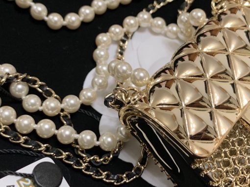 CHANEL Long Necklace. Authentic quality luxury bag crafted in genuine leather comes with authenticity card, dust bag and gift bag. Adorn yourself with timeless elegance. Introducing the exquisite CHANEL Long Necklace in a captivating combination of Gold, Black, and Pearly White, which proudly belongs to the esteemed Spring-Summer 2021 fashion collection. Meticulously designed and masterfully crafted, this stunning piece showcases the exceptional artistry and dedication synonymous with the iconic House of CHANEL.