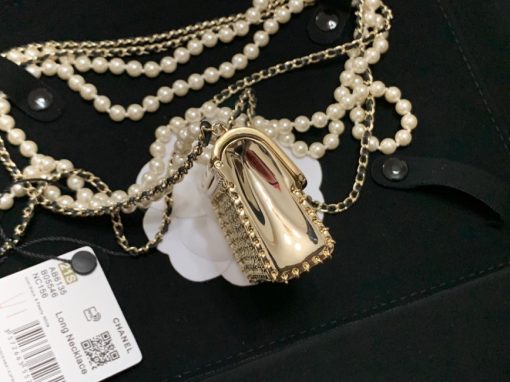 CHANEL Long Necklace. Authentic quality luxury bag crafted in genuine leather comes with authenticity card, dust bag and gift bag. Adorn yourself with timeless elegance. Introducing the exquisite CHANEL Long Necklace in a captivating combination of Gold, Black, and Pearly White, which proudly belongs to the esteemed Spring-Summer 2021 fashion collection. Meticulously designed and masterfully crafted, this stunning piece showcases the exceptional artistry and dedication synonymous with the iconic House of CHANEL.