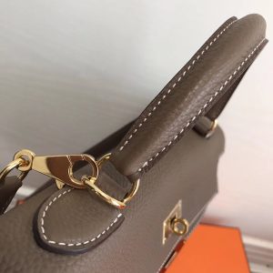 HERMÈS 'Kelly' Sellier Calf Leather Shoulder Bag. Authentic quality luxury bag crafted in genuine leather comes with authenticity card, dust bag and gift bag. Timeless Elegance, From Grace to Iconography. In 1930, a century after HERMÈS first opened its saddle-making workshops, Robert Dumas introduced a charming new creation for women - a small bag with straps. This bag featured a trapezoid shape, two triangular gussets, a sculpted flap, a handle, and ample storage space. Its design was simple and practical, tailored specifically for independent and energetic women. The bag with straps quickly became iconic for HERMÈS, embodying both desirability and discreetness. Then, in 1956, a significant moment occurred. Grace Kelly, the renowned Hollywood star turned princess, artfully concealed her baby bump behind her HERMÈS bag with straps. This image spread worldwide, instantly catapulting the bag into the limelight. And thus, the Kelly bag was born. - KRIS + KIKO HERMÈS 'Kelly' Sellier Calf Leather Shoulder Bag. Original Quality Bag. Gold-metal toned Hardware. HERMÈS Sales Box and Dust Bag. Booklet, Authenticity Card, Payment Slip. Lock, key clochette, and two keys are included. 1930, a century after the house of HERMÈS opened the doors of its saddle-making workshops, Robert Dumas created a small bag with straps for ladies. It had a trapezoid shape, two triangular gussets, a sculpted flap, a handle, and good storage space. Nothing fancy, just a neat, plain, functional bag intended for independent, energetic women. The ladies’ bag with straps was an emblematic HERMÈS design: both highly desirable yet anonymous. 1956, Grace Kelly, the Hollywood star who became a princess, hides her baby bump behind her Hermès bag with straps. The picture goes around the world, and the bag is instantly crowned. The Kelly bag is born.