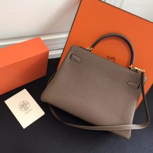 HERMÈS 'Kelly' Sellier Calf Leather Shoulder Bag. Authentic quality luxury bag crafted in genuine leather comes with authenticity card, dust bag and gift bag. Timeless Elegance, From Grace to Iconography. In 1930, a century after HERMÈS first opened its saddle-making workshops, Robert Dumas introduced a charming new creation for women - a small bag with straps. This bag featured a trapezoid shape, two triangular gussets, a sculpted flap, a handle, and ample storage space. Its design was simple and practical, tailored specifically for independent and energetic women. The bag with straps quickly became iconic for HERMÈS, embodying both desirability and discreetness. Then, in 1956, a significant moment occurred. Grace Kelly, the renowned Hollywood star turned princess, artfully concealed her baby bump behind her HERMÈS bag with straps. This image spread worldwide, instantly catapulting the bag into the limelight. And thus, the Kelly bag was born. - KRIS + KIKO HERMÈS 'Kelly' Sellier Calf Leather Shoulder Bag. Authentic quality luxury bag crafted in genuine leather comes with authenticity card, dust bag and gift bag. Timeless Elegance, From Grace to Iconography. In 1930, a century after HERMÈS first opened its saddle-making workshops, Robert Dumas introduced a charming new creation for women - a small bag with straps. This bag featured a trapezoid shape, two triangular gussets, a sculpted flap, a handle, and ample storage space. Its design was simple and practical, tailored specifically for independent and energetic women. The bag with straps quickly became iconic for HERMÈS, embodying both desirability and discreetness. Then, in 1956, a significant moment occurred. Grace Kelly, the renowned Hollywood star turned princess, artfully concealed her baby bump behind her HERMÈS bag with straps. This image spread worldwide, instantly catapulting the bag into the limelight. And thus, the Kelly bag was born.