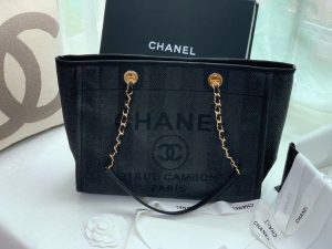 CHANEL Large Deauville Shopping Bag 2021. Authentic quality luxury bag crafted in genuine leather comes with authenticity card, dust bag and gift bag. Classic Elegance Meets Enduring Style. The CHANEL Deauville tote has evolved into an iconic CHANEL bag, gaining recognition as a popular choice. It frequently makes appearances in seasonal collections, showcasing surprising hues and materials. Interestingly, on the CHANEL website, it is referred to as the Shopping Bag; however, if you visit a CHANEL boutique and inquire about the Deauville, you will be guided to this exquisite tote bag. - KRIS + KIKO CHANEL Large Deauville Shopping Bag 2021. Authentic quality bag including gift box, booklet, dust bag, authenticity card. The CHANEL Deauville tote matured to a signature CHANEL bag. The bestseller Deauville often appears in seasonal launches in unexpected colors and materials. On the CHANEL website, Chanel calls it the Shopping Bag, but if you walk into a CHANEL boutique and ask for the Deauville, you will be directed to this tote bag.