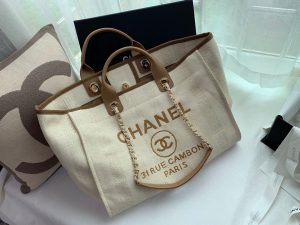 CHANEL Large Deauville Shopping Bag 2021. Authentic quality luxury bag crafted in genuine leather comes with authenticity card, dust bag and gift bag. Classic Elegance Meets Enduring Style. The CHANEL Deauville tote has evolved into an iconic CHANEL bag, gaining recognition as a popular choice. It frequently makes appearances in seasonal collections, showcasing surprising hues and materials. Interestingly, on the CHANEL website, it is referred to as the Shopping Bag; however, if you visit a CHANEL boutique and inquire about the Deauville, you will be guided to this exquisite tote bag. - KRIS + KIKO CHANEL Large Deauville Shopping Bag 2021. Authentic quality bag including gift box, booklet, dust bag, authenticity card. The CHANEL Deauville tote matured to a signature CHANEL bag. The bestseller Deauville often appears in seasonal launches in unexpected colors and materials. On the CHANEL website, Chanel calls it the Shopping Bag, but if you walk into a CHANEL boutique and ask for the Deauville, you will be directed to this tote bag.