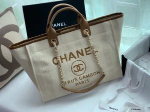 CHANEL Large Deauville Shopping Bag 2021. Authentic quality luxury bag crafted in genuine leather comes with authenticity card, dust bag and gift bag. Classic Elegance Meets Enduring Style. The CHANEL Deauville tote has evolved into an iconic CHANEL bag, gaining recognition as a popular choice. It frequently makes appearances in seasonal collections, showcasing surprising hues and materials. Interestingly, on the CHANEL website, it is referred to as the Shopping Bag; however, if you visit a CHANEL boutique and inquire about the Deauville, you will be guided to this exquisite tote bag. - KRIS + KIKO CHANEL Large Deauville Shopping Bag 2021. Authentic quality bag including gift box, booklet, dust bag, authenticity card. The CHANEL Deauville tote matured to a signature CHANEL bag. The bestseller Deauville often appears in seasonal launches in unexpected colors and materials. On the CHANEL website, Chanel calls it the Shopping Bag, but if you walk into a CHANEL boutique and ask for the Deauville, you will be directed to this tote bag.