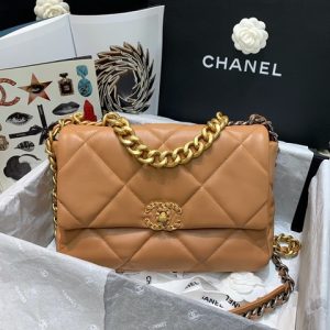 CHANEL '19' Flap Bag. Authentic quality luxury bag crafted in genuine leather comes with authenticity card, dust bag and gift bag. A Timeless Evolution of Elegance. Chanel's latest masterpiece, the Chanel 19 Bag, is the result of a collaboration with the brilliant designer Virginie Viard. This exquisite creation took center stage at the prestigious Paris Fashion Week, captivating fashion enthusiasts from around the world. Aptly named after its birth year, the Chanel 19 Bag draws inspiration from the iconic 2.55 bag, paying homage to its timeless elegance. - KRIS + KIKO CHANEL '19' Flap Bag. High-end quality bag including gift box, literature, dust bag, authenticity card. Chanel's newest bag was designed along with Virginie Viard, and it made its debut on the runway of Paris Fashion Week earlier this year. The bag, called the Chanel 19 Bag, is aptly named after its birth year, and it is said to be inspired by the classic 2.55 bag.