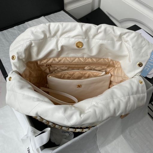 22 Small Handbag. Authentic quality luxury bag crafted in genuine leather comes with authenticity card, dust bag and gift bag. Embrace effortless elegance with this Chanel 22 Bag - where timeless style meets everyday versatility. Presenting the Chanel 22 Bag, expertly designed by Virginie Viard and named in honor of its birth year, 2022. This new addition to the Chanel collection is a delightful drawstring-shaped bag that exudes casual-chic charm, perfect for everyday use. Part of the Spring Summer 2022 Collection Act 2, this bag has been carefully crafted with convenience in mind, utilizing lightweight materials and durable leather. Its understated yet sophisticated appearance is enhanced by diamond quilting on the body, creating an elegant texture without any inflated effect. To provide effortless comfort, the bag features a woven chain leather strap for shoulder carry, complete with a charming vintage accessory. Finally, at the heart of the bag proudly resides the iconic 'Chanel' logo, embodying the prestigious heritage of the fashion house.