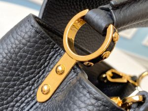 LOUIS VUITTON Capucines Mini. Authentic quality luxury bag crafted in genuine leather comes with authenticity card, dust bag and gift bag. Captivatingly vibrant. Effortlessly sophisticated. Crafted from vibrant Taurillon leather, the Capucines Mini handbag exudes an exquisite charm. Its striking color palette is tastefully enhanced by the understated metal handle rings. Just like every Capucines, this Mini version can be effortlessly carried with the flap out, adding an air of effortless elegance, or tucked inside to showcase the iconic LV Initials. - KRIS + KIKO LOUIS VUITTON Capucines Mini. Original Quality Bag including gift box, literature, dust bag, authenticity card. Fashioned from vibrantly colored Taurillon leather, the Capucines Mini handbag pops. The fresh new colorway is perfectly complemented by the discreet metal handle rings. Like all Capucines, the Mini can be carried with the flap out for simple sophistication or tucked inside to feature the LV Initials.