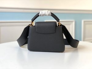 LOUIS VUITTON Capucines Mini. Authentic quality luxury bag crafted in genuine leather comes with authenticity card, dust bag and gift bag. Captivatingly vibrant. Effortlessly sophisticated. Crafted from vibrant Taurillon leather, the Capucines Mini handbag exudes an exquisite charm. Its striking color palette is tastefully enhanced by the understated metal handle rings. Just like every Capucines, this Mini version can be effortlessly carried with the flap out, adding an air of effortless elegance, or tucked inside to showcase the iconic LV Initials. - KRIS + KIKO LOUIS VUITTON Capucines Mini. Original Quality Bag including gift box, literature, dust bag, authenticity card. Fashioned from vibrantly colored Taurillon leather, the Capucines Mini handbag pops. The fresh new colorway is perfectly complemented by the discreet metal handle rings. Like all Capucines, the Mini can be carried with the flap out for simple sophistication or tucked inside to feature the LV Initials.
