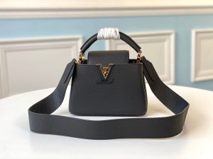LOUIS VUITTON Capucines Mini. Authentic quality luxury bag crafted in genuine leather comes with authenticity card, dust bag and gift bag. Captivatingly vibrant. Effortlessly sophisticated. Crafted from vibrant Taurillon leather, the Capucines Mini handbag exudes an exquisite charm. Its striking color palette is tastefully enhanced by the understated metal handle rings. Just like every Capucines, this Mini version can be effortlessly carried with the flap out, adding an air of effortless elegance, or tucked inside to showcase the iconic LV Initials. - KRIS + KIKO LOUIS VUITTON Capucines Mini. Original Quality Bag including gift box, literature, dust bag, authenticity card. Fashioned from vibrantly colored Taurillon leather, the Capucines Mini handbag pops. The fresh new colorway is perfectly complemented by the discreet metal handle rings. Like all Capucines, the Mini can be carried with the flap out for simple sophistication or tucked inside to feature the LV Initials.