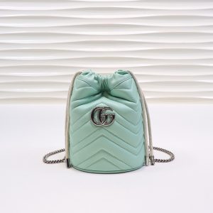 GUCCI GG Marmont Mini Bucket Bag. Authentic quality luxury bag crafted in genuine leather comes with authenticity card, dust bag and gift bag. Unleash the Vibrant Charm of Timeless Elegance. Introducing the latest addition to the GG Marmont collection: the mini bucket bag in stunning vibrant tones, meticulously crafted from Matelassé leather. This exquisite piece draws inspiration from a timeless '70s design, symbolizing the essence of the House. The iconic Double G emblem adorns the front of this accessory, further elevating its allure. With its convenient chain strap and elegant drawstring closure, this versatile bag effortlessly transitions from a shoulder bag to a crossbody one. Experience the epitome of style and functionality with this remarkable creation. - KRIS + KIKO GUCCI GG Marmont Mini Bucket Bag. Original Quality Bag including gift box, literature, dust bag, authenticity card. The world of GG Marmont expands with the introduction of a mini bucket bag shape crafted from Matelassé leather in vibrant tones. Inspired by an archival design from the '70s, a hallmark era of the House, the Double G decorates the front of this accessory. Featuring a chain strap and drawstring closure the versatile shape can be worn as shoulder and as a crossbody bag.