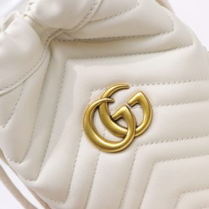 GUCCI GG Marmont Mini Bucket Bag. Authentic quality luxury bag crafted in genuine leather comes with authenticity card, dust bag and gift bag. Unleash the Vibrant Charm of Timeless Elegance. Introducing the latest addition to the GG Marmont collection: the mini bucket bag in stunning vibrant tones, meticulously crafted from Matelassé leather. This exquisite piece draws inspiration from a timeless '70s design, symbolizing the essence of the House. The iconic Double G emblem adorns the front of this accessory, further elevating its allure. With its convenient chain strap and elegant drawstring closure, this versatile bag effortlessly transitions from a shoulder bag to a crossbody one. Experience the epitome of style and functionality with this remarkable creation. - KRIS + KIKO GUCCI GG Marmont Mini Bucket Bag. Authentic quality luxury bag crafted in genuine leather comes with authenticity card, dust bag and gift bag. Unleash the Vibrant Charm of Timeless Elegance. Introducing the latest addition to the GG Marmont collection: the mini bucket bag in stunning vibrant tones, meticulously crafted from Matelassé leather. This exquisite piece draws inspiration from a timeless '70s design, symbolizing the essence of the House. The iconic Double G emblem adorns the front of this accessory, further elevating its allure. With its convenient chain strap and elegant drawstring closure, this versatile bag effortlessly transitions from a shoulder bag to a crossbody one. Experience the epitome of style and functionality with this remarkable creation.