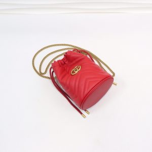 GUCCI GG Marmont Mini Bucket Bag. Authentic quality luxury bag crafted in genuine leather comes with authenticity card, dust bag and gift bag. Unleash the Vibrant Charm of Timeless Elegance. Introducing the latest addition to the GG Marmont collection: the mini bucket bag in stunning vibrant tones, meticulously crafted from Matelassé leather. This exquisite piece draws inspiration from a timeless '70s design, symbolizing the essence of the House. The iconic Double G emblem adorns the front of this accessory, further elevating its allure. With its convenient chain strap and elegant drawstring closure, this versatile bag effortlessly transitions from a shoulder bag to a crossbody one. Experience the epitome of style and functionality with this remarkable creation. - KRIS + KIKO GUCCI GG Marmont Mini Bucket Bag. Authentic quality luxury bag crafted in genuine leather comes with authenticity card, dust bag and gift bag. Unleash the Vibrant Charm of Timeless Elegance. Introducing the latest addition to the GG Marmont collection: the mini bucket bag in stunning vibrant tones, meticulously crafted from Matelassé leather. This exquisite piece draws inspiration from a timeless '70s design, symbolizing the essence of the House. The iconic Double G emblem adorns the front of this accessory, further elevating its allure. With its convenient chain strap and elegant drawstring closure, this versatile bag effortlessly transitions from a shoulder bag to a crossbody one. Experience the epitome of style and functionality with this remarkable creation.