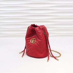 GUCCI GG Marmont Mini Bucket Bag. Authentic quality luxury bag crafted in genuine leather comes with authenticity card, dust bag and gift bag. Unleash the Vibrant Charm of Timeless Elegance. Introducing the latest addition to the GG Marmont collection: the mini bucket bag in stunning vibrant tones, meticulously crafted from Matelassé leather. This exquisite piece draws inspiration from a timeless '70s design, symbolizing the essence of the House. The iconic Double G emblem adorns the front of this accessory, further elevating its allure. With its convenient chain strap and elegant drawstring closure, this versatile bag effortlessly transitions from a shoulder bag to a crossbody one. Experience the epitome of style and functionality with this remarkable creation. - KRIS + KIKO GUCCI GG Marmont Mini Bucket Bag. Original Quality Bag including gift box, literature, dust bag, authenticity card. The world of GG Marmont expands with the introduction of a mini bucket bag shape crafted from Matelassé leather in vibrant tones. Inspired by an archival design from the '70s, a hallmark era of the House, the Double G decorates the front of this accessory. Featuring a chain strap and drawstring closure the versatile shape can be worn as shoulder and as a crossbody bag.